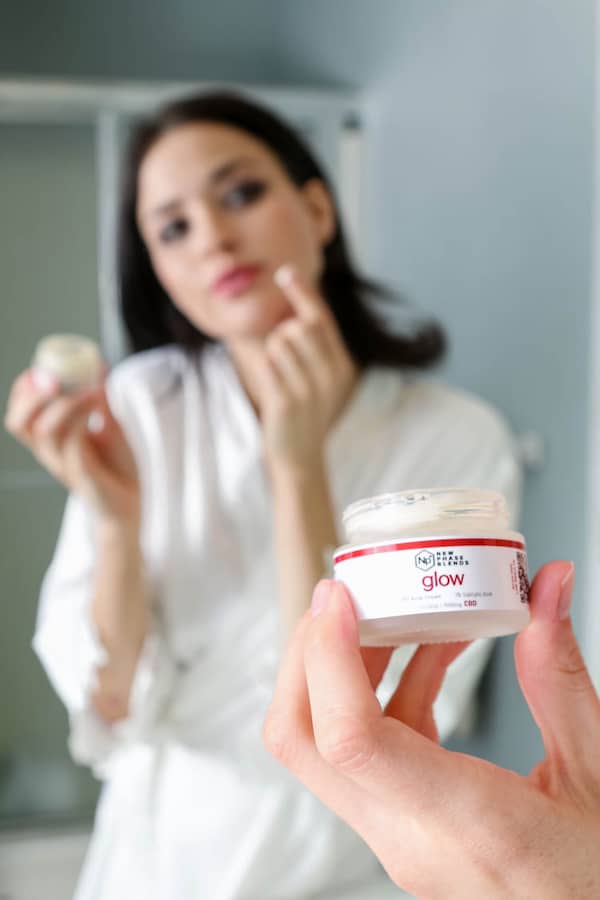 CBD for Acne Management: Does it Work? 5 applying glow in the bathroom mirror
